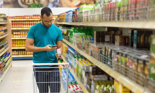 focused-african-american-man-reading-shopping-list-smartphone_74855-3412