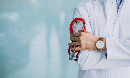 Young handsome physician in a medical robe with stethoscope